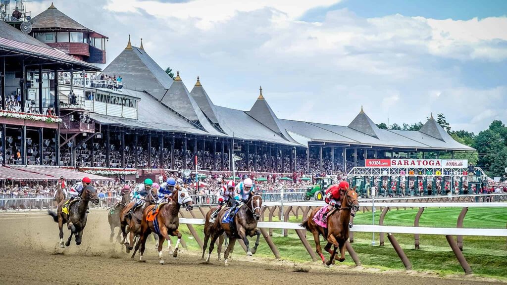 Racehorse jockeys competing in a horse race at Saratoga Race Course.