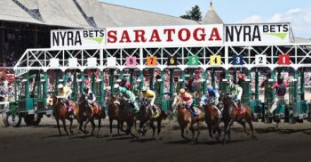 Exciting thoroughbred horse race starting at Saratoga Race Course with horses and jockeys, capturing the thrill of live horse racing.